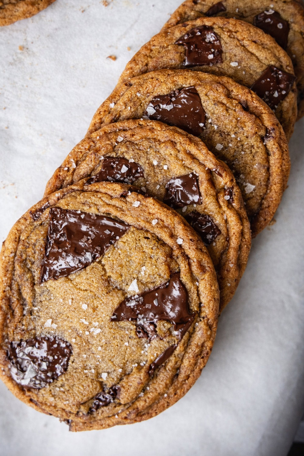 Stack of chocolate chunk cookies on a white surface